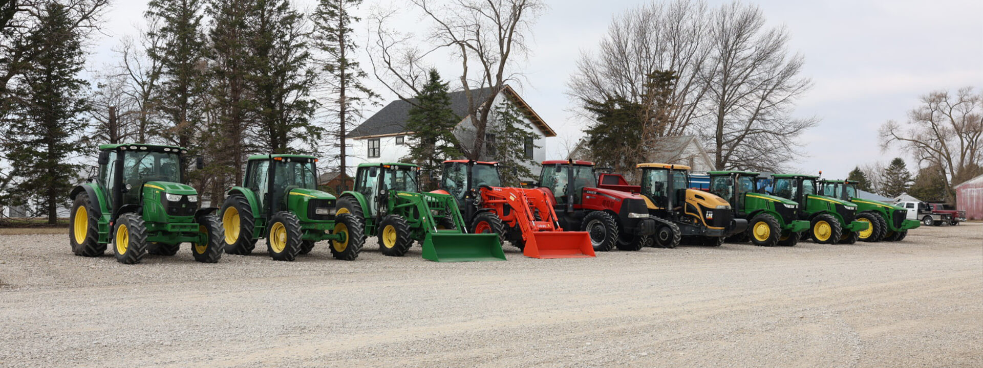 Lineup of Case and John Deere tractors second view