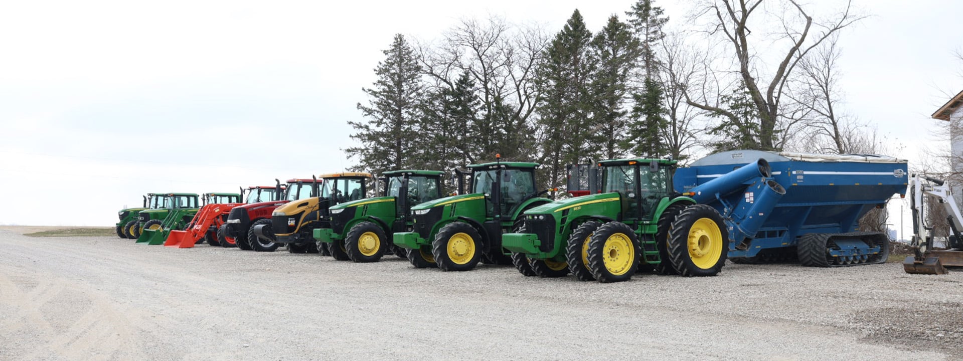 Lineup of Case and John Deere tractors third view