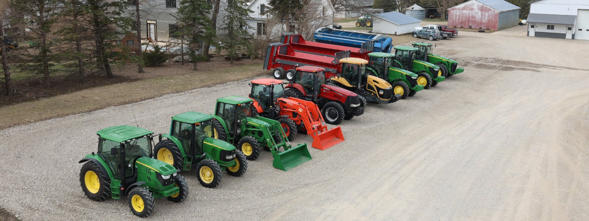 Lineup of Case and John Deere tractors side top view