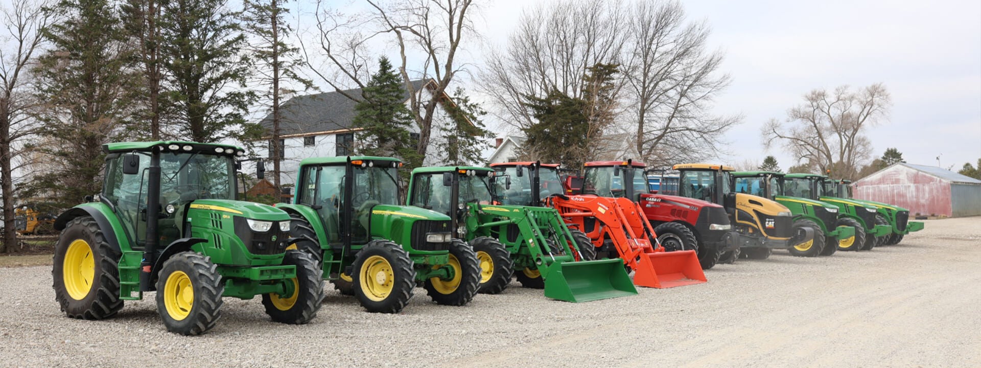 Lineup of Case and John Deere tractors close up of JohnDeere