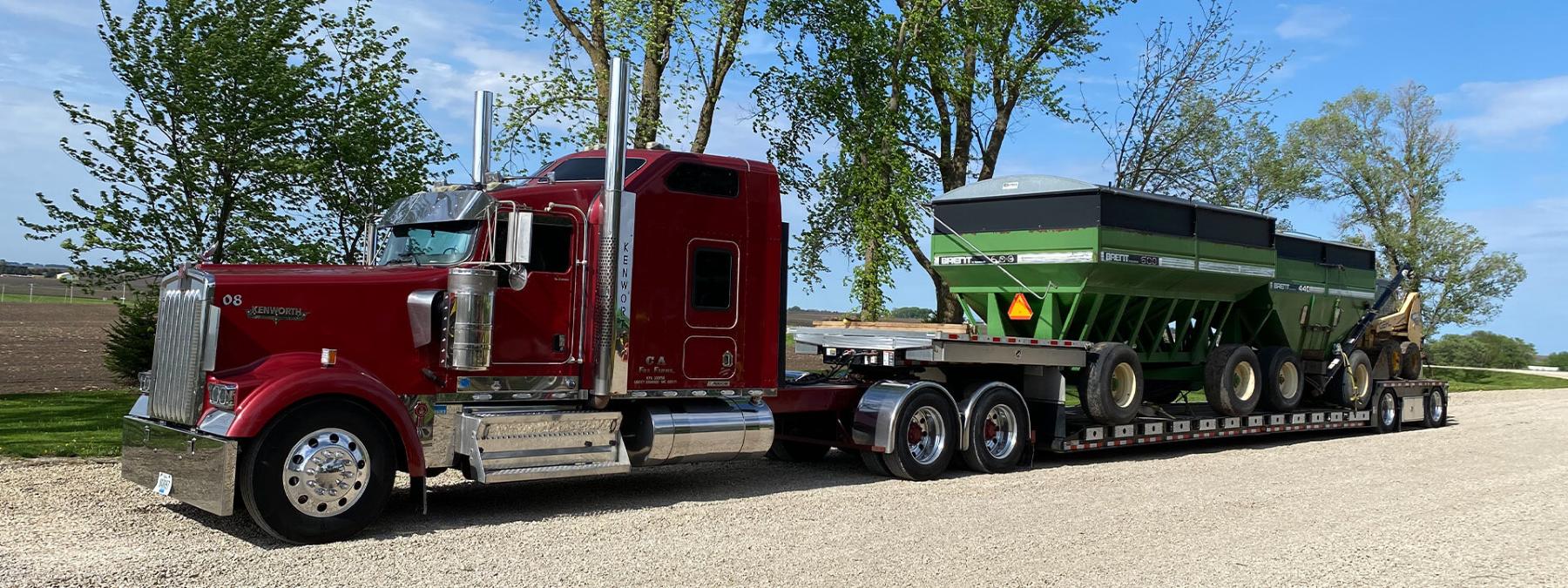 Semi carrying two seed tank seed tenders in trailer